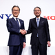 Sony president and CEO Kenichiro Yoshida, left, shakes hands with Honda president Toshihiro Mibe.